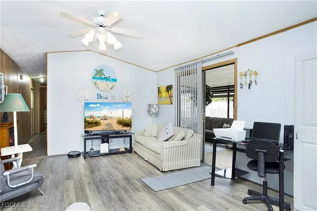 a living room with furniture and wooden floor