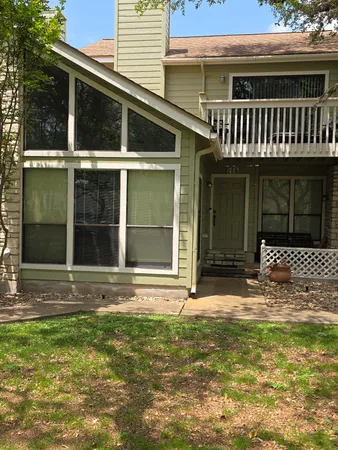 a view of a house with a large window and yard