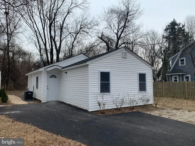 a view of a white house with a large space