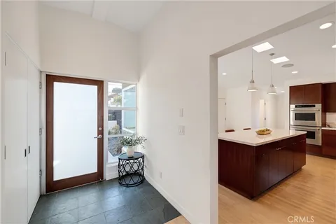 a view of kitchen with kitchen island stainless steel appliances a sink stove and refrigerator
