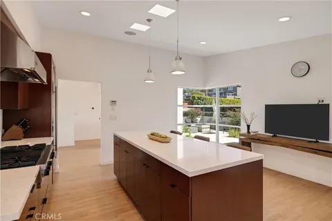 a kitchen with a stove a refrigerator and a sink
