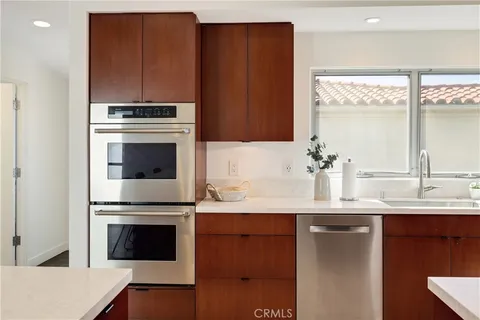 a kitchen with granite countertop a stove a sink and a microwave