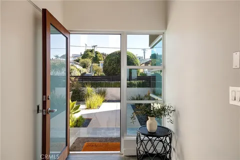 a room with water view and a potted plant on the side of a glass door
