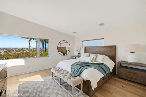 a bed sitting in a bedroom next to a window with pc on the wall