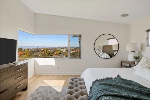 a bedroom with a bed and a mirror