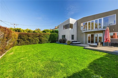 a view of a house with backyard porch and sitting area