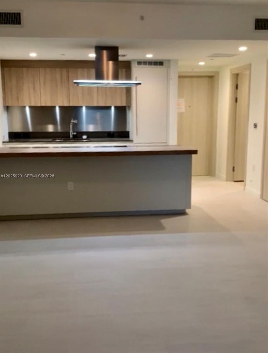 1000 Brickell, Unit 2014 Miami, FL 33131 - Photo 20 of 30 a view of kitchen with stainless steel appliances granite countertop a stove a sink and a microwave