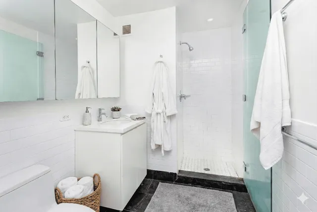 a bedroom with bed and a book shelf