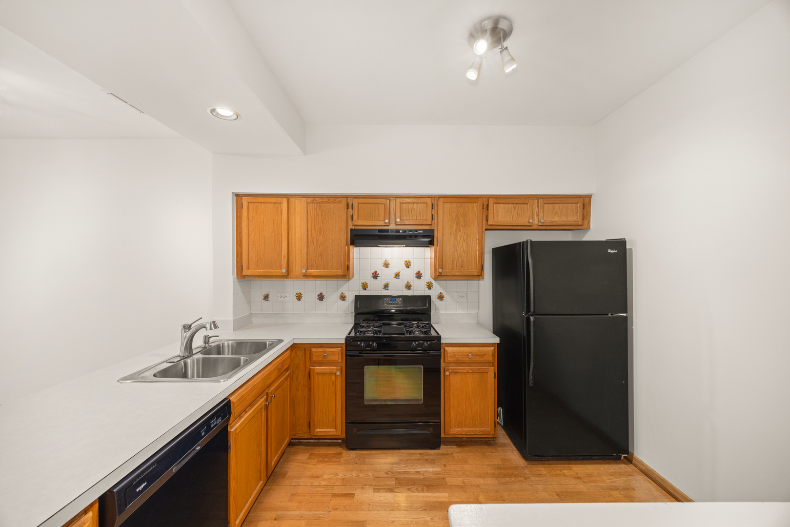 100 Harvest Gate, Unit 100 Lake In The Hills, IL 60156 - Photo 5 of 17 a kitchen with a refrigerator and a stove