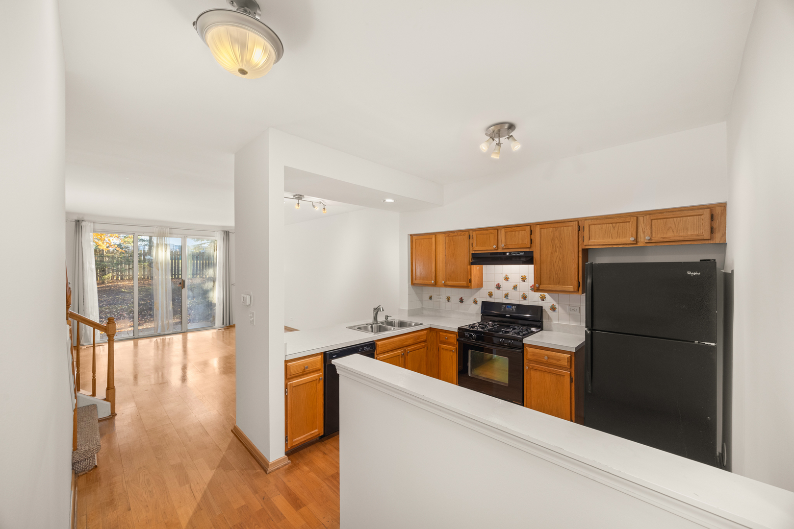 100 Harvest Gate, Unit 100 Lake In The Hills, IL 60156 - Photo 6 of 17 a kitchen with granite countertop a refrigerator and a stove top oven