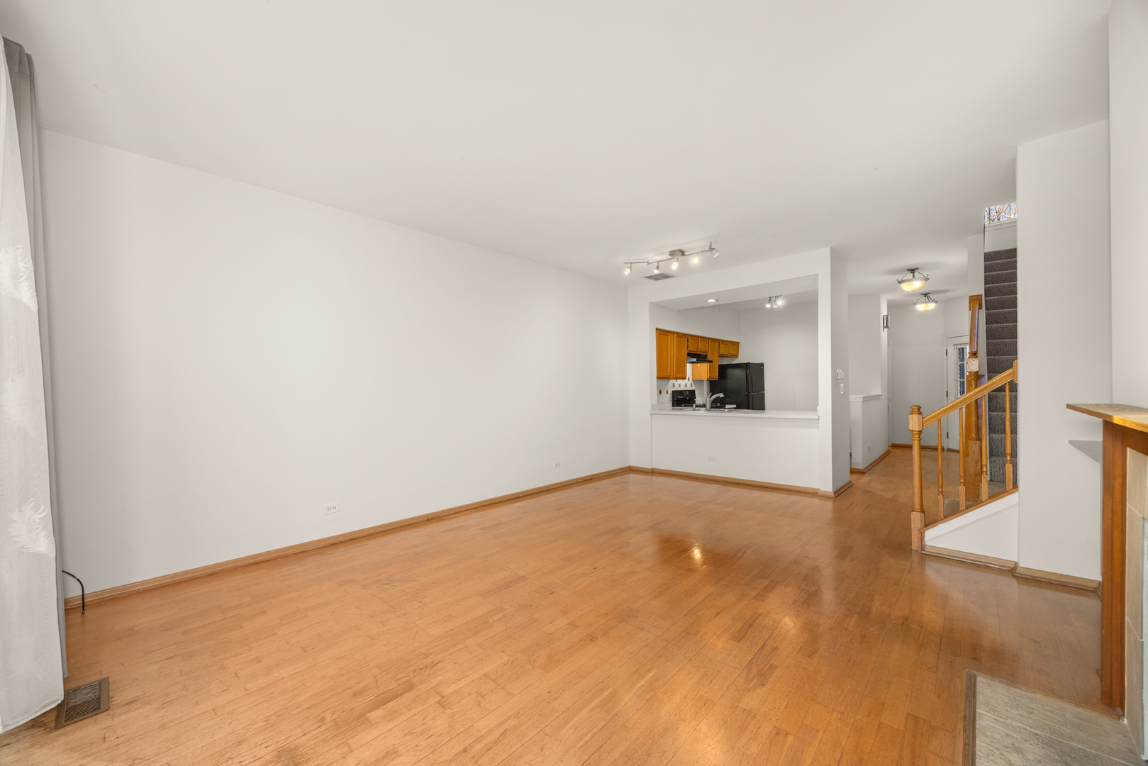 100 Harvest Gate, Unit 100 Lake In The Hills, IL 60156 - Photo 7 of 17 a view of a big room with wooden floor and a large window