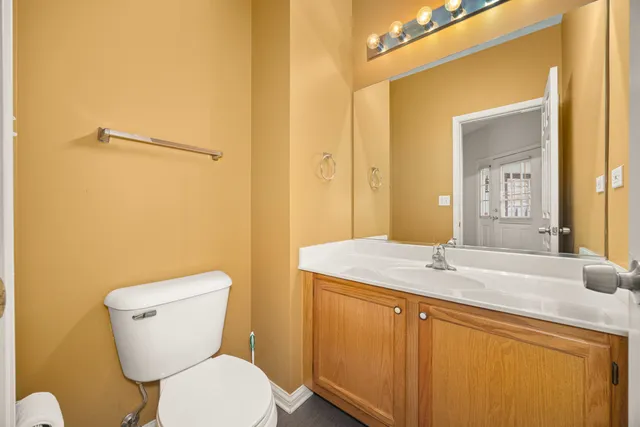 a bathroom with a sink a toilet a mirror and shower