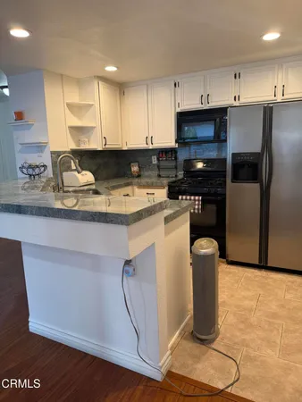 a kitchen with a sink appliances and cabinets