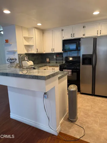 a kitchen with a sink appliances and cabinets
