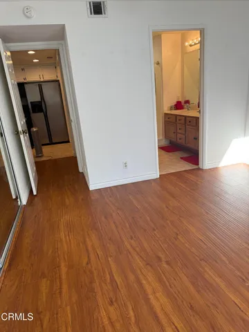 a view of a room with wooden floor and closet