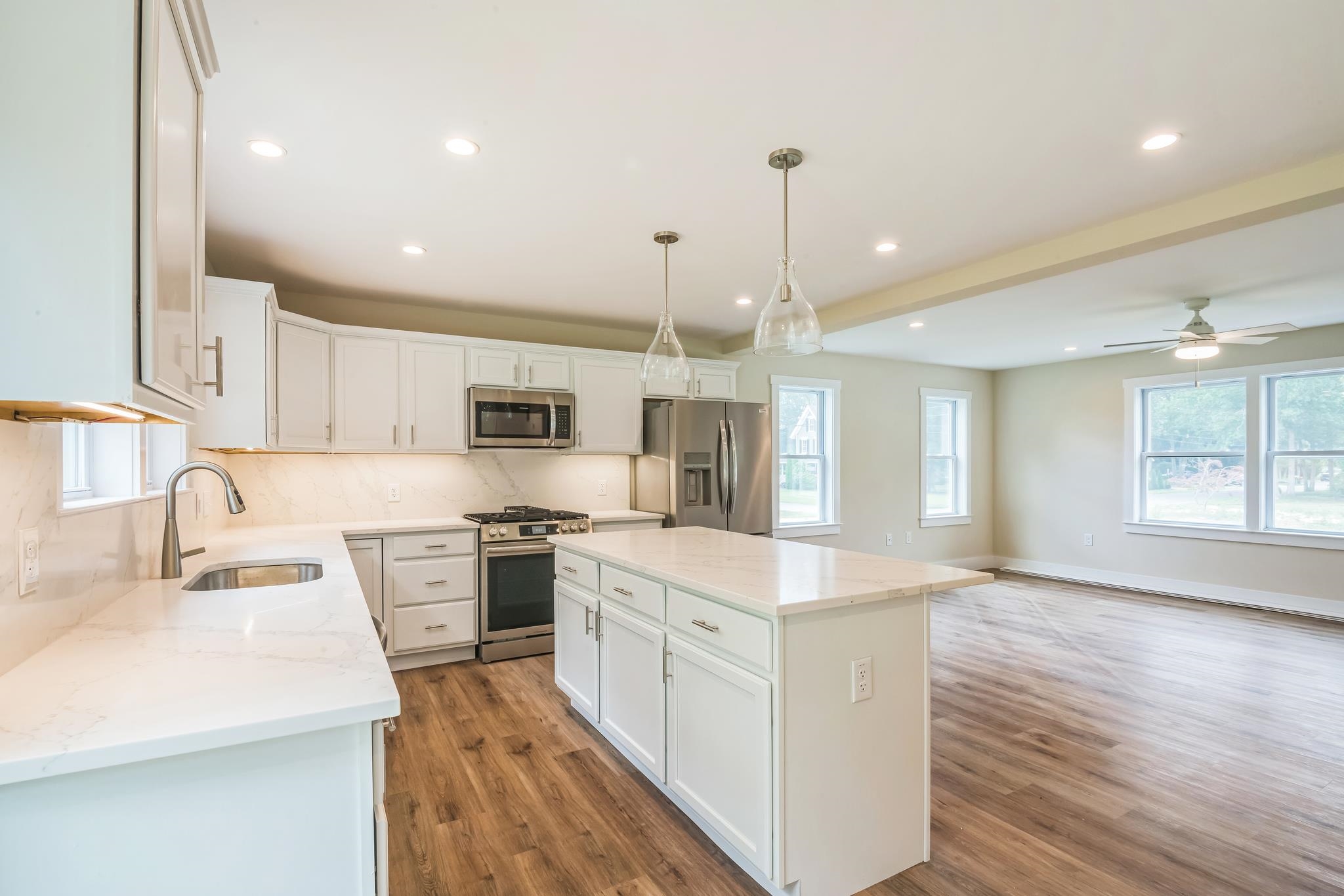 70 West Rising Sun Drive Ocean View, NJ 08230 - Photo 13 of 34 a large kitchen with stainless steel appliances kitchen island granite countertop a sink a stove and a refrigerator