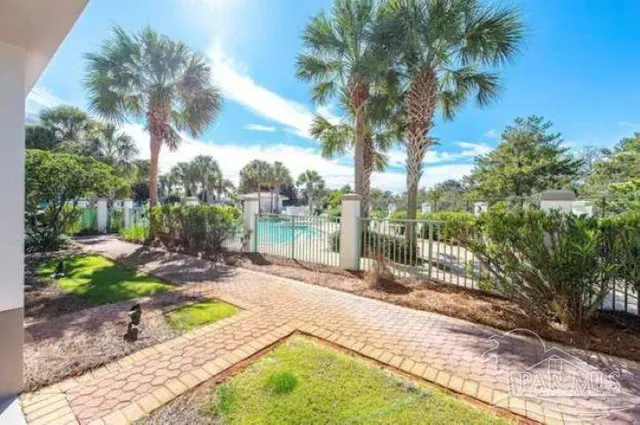 a view of a backyard with plants and lake view