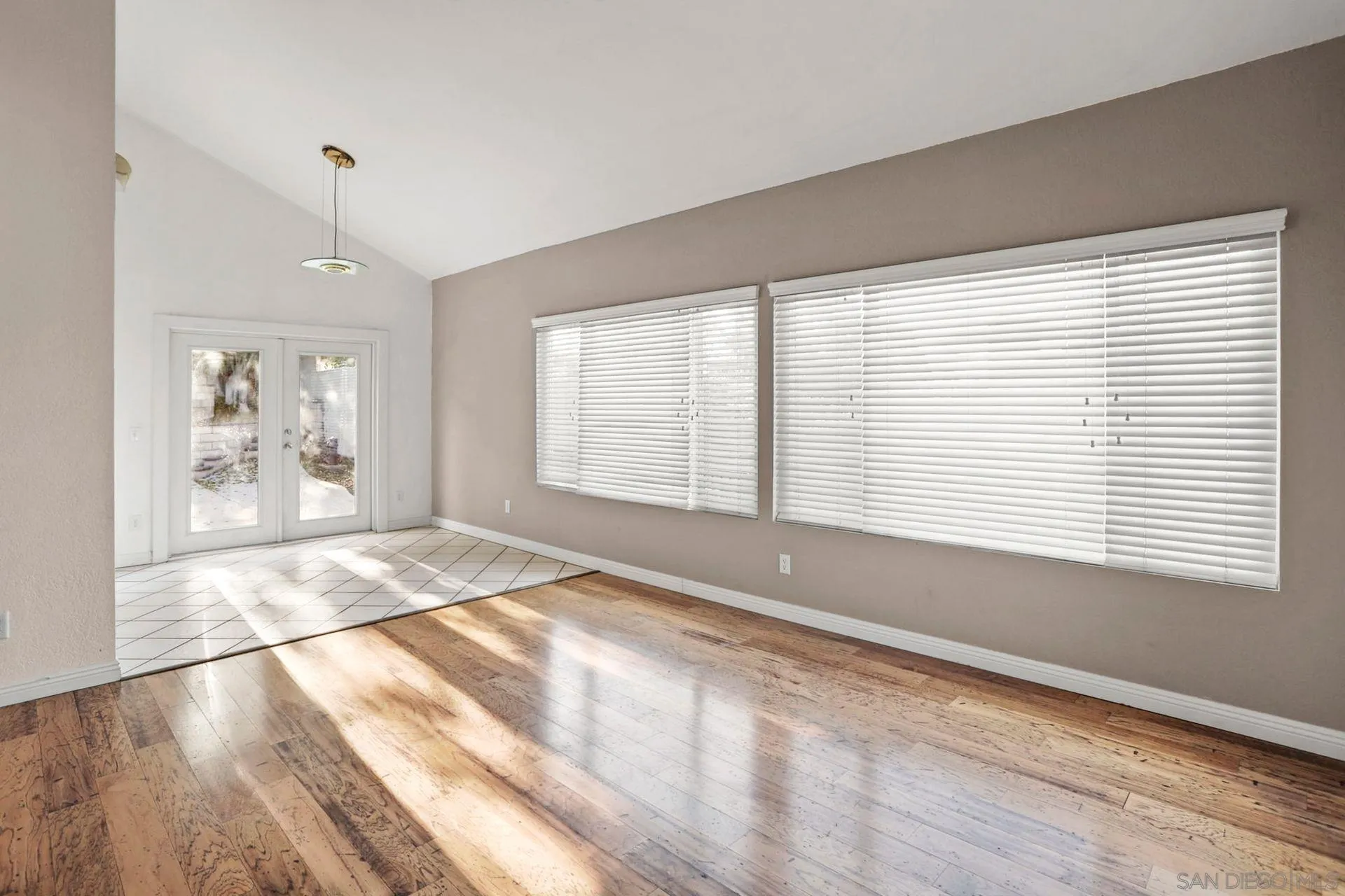 8333 Oconnell Road El Cajon, CA 92021 - Photo 11 of 32 a view of an empty room with wooden floor and a window