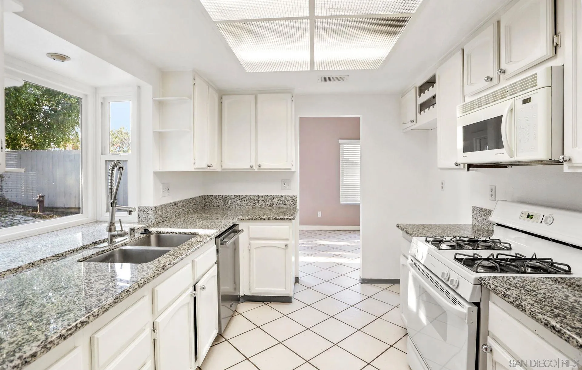 8333 Oconnell Road El Cajon, CA 92021 - Photo 16 of 32 a kitchen with granite countertop a sink stove and cabinets