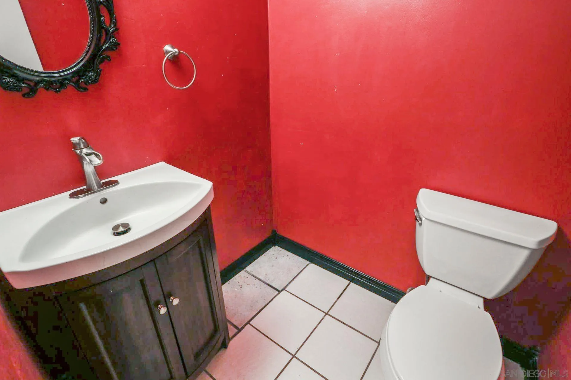 8333 Oconnell Road El Cajon, CA 92021 - Photo 26 of 32 a bathroom with a toilet a sink and mirror