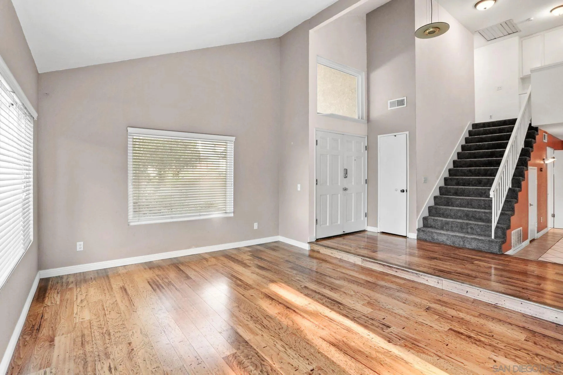 8333 Oconnell Road El Cajon, CA 92021 - Photo 7 of 32 a view of an empty room with wooden floor and a window