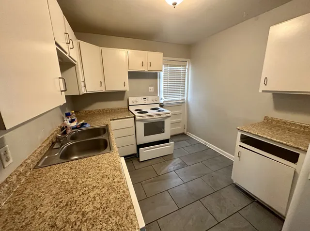 a kitchen with a stove a sink and a microwave