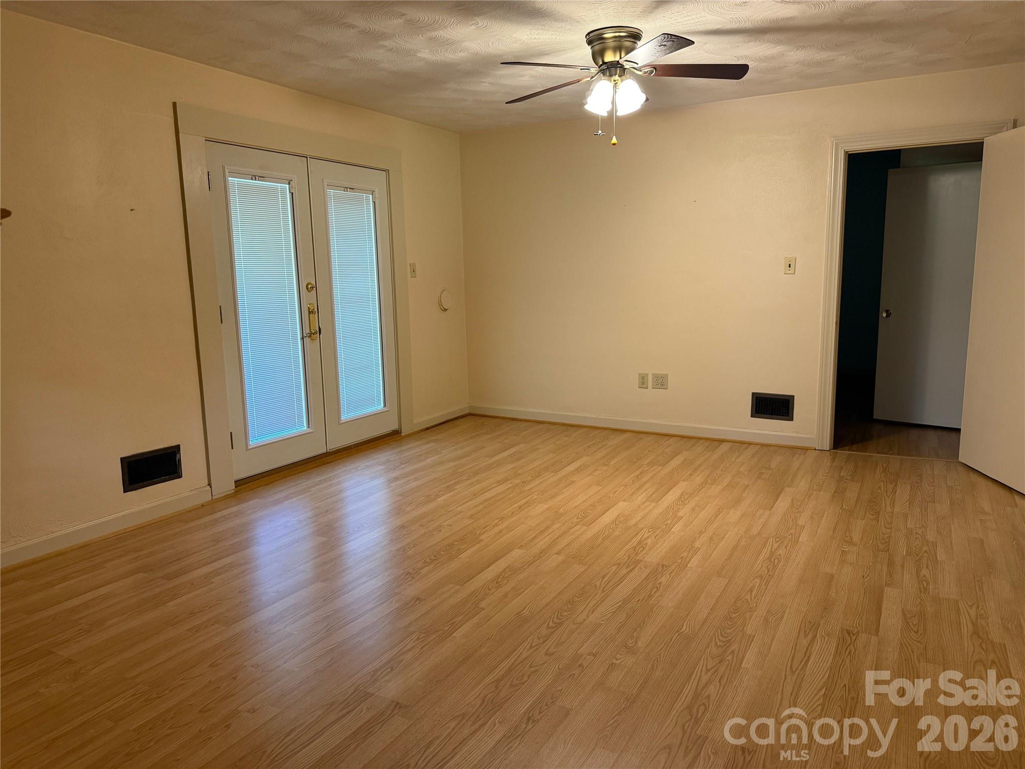 3532 16th Street Northeast, Unit 1 Hickory, NC 28601 - Photo 13 of 43 an empty room with wooden floor chandelier fan and windows