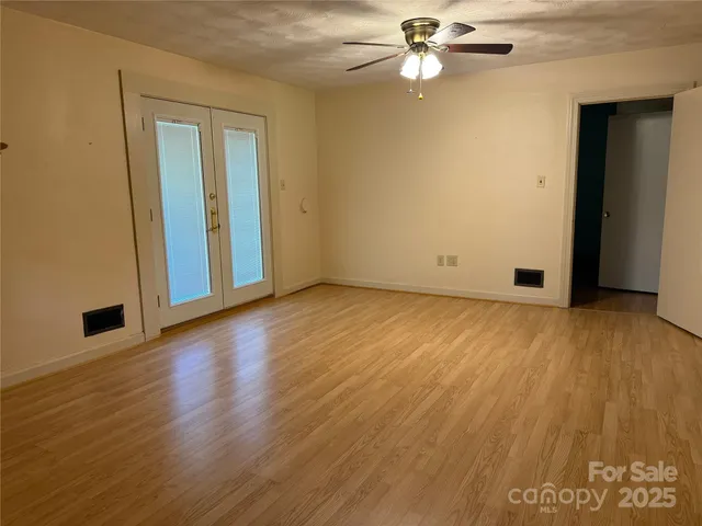 an empty room with wooden floor and closet