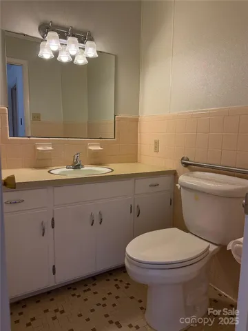 an empty room with wooden floor and a hallway