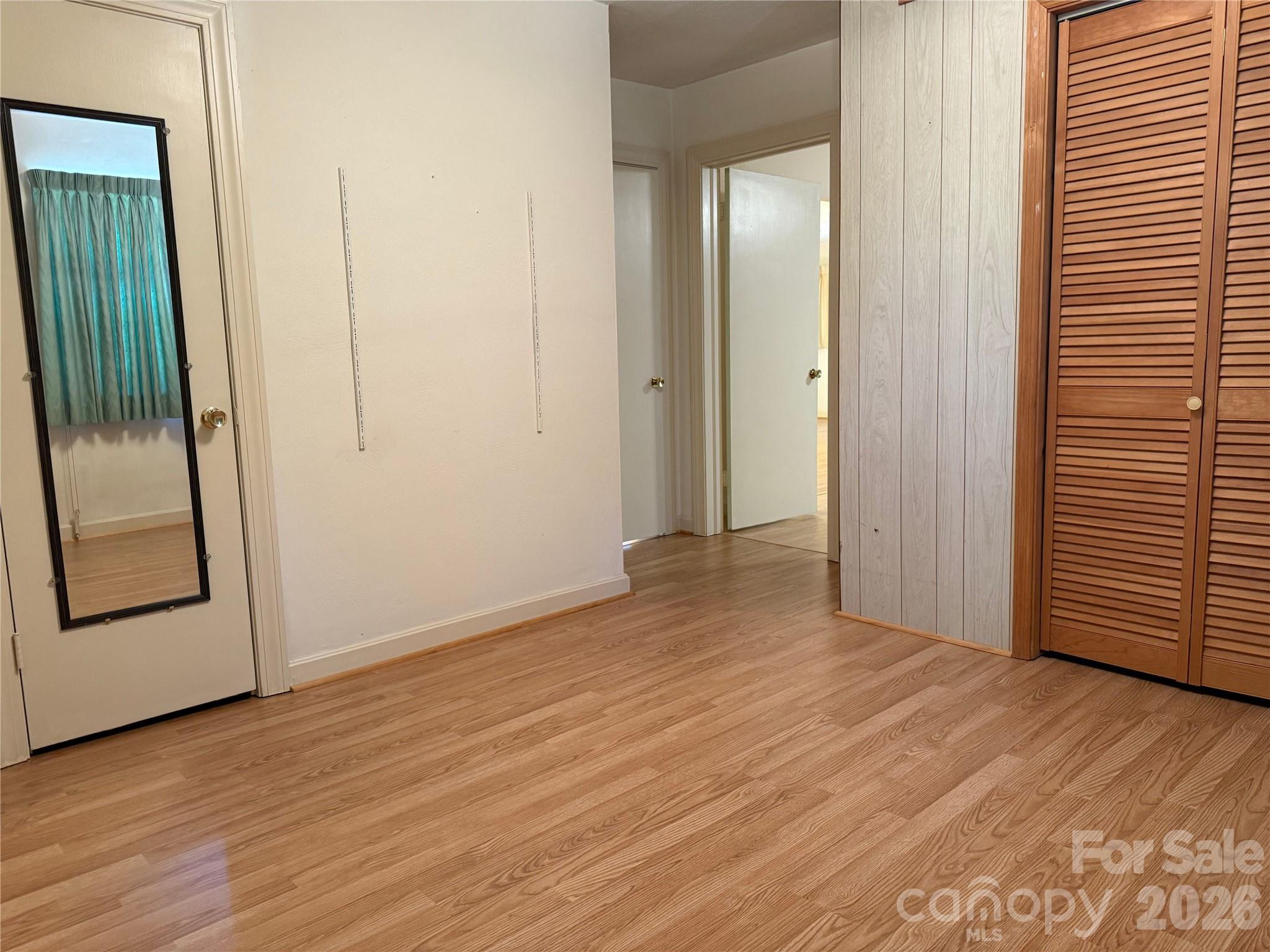 3532 16th Street Northeast, Unit 1 Hickory, NC 28601 - Photo 25 of 43 an empty room with wooden floor and a hallway