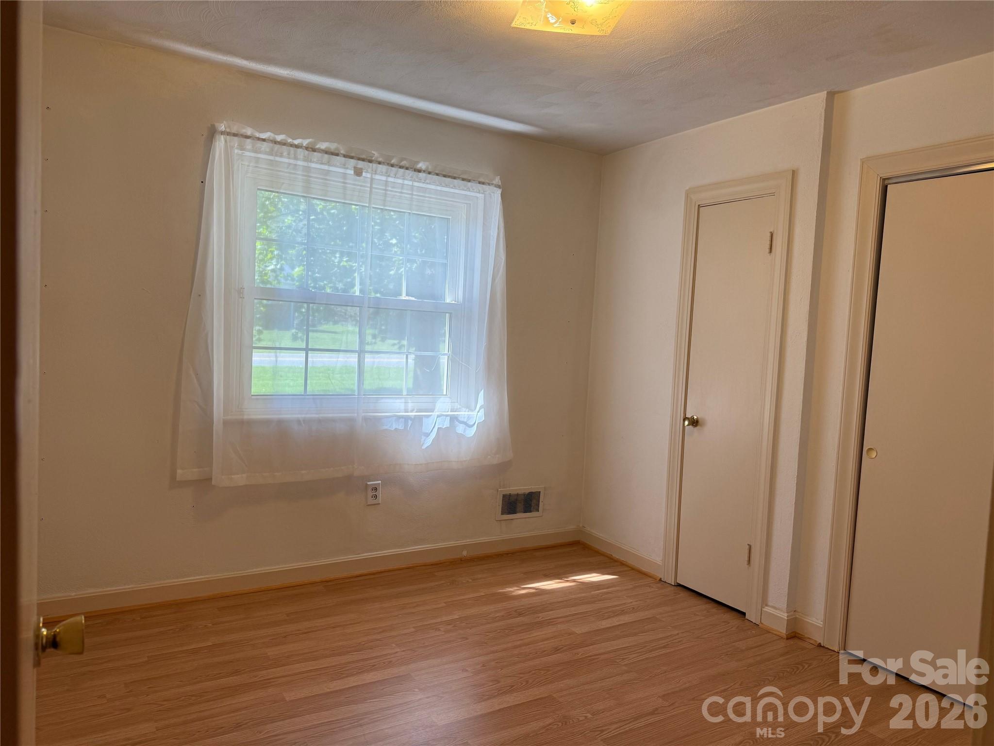 3532 16th Street Northeast, Unit 1 Hickory, NC 28601 - Photo 26 of 43 a view of an empty room with wooden floor and a window