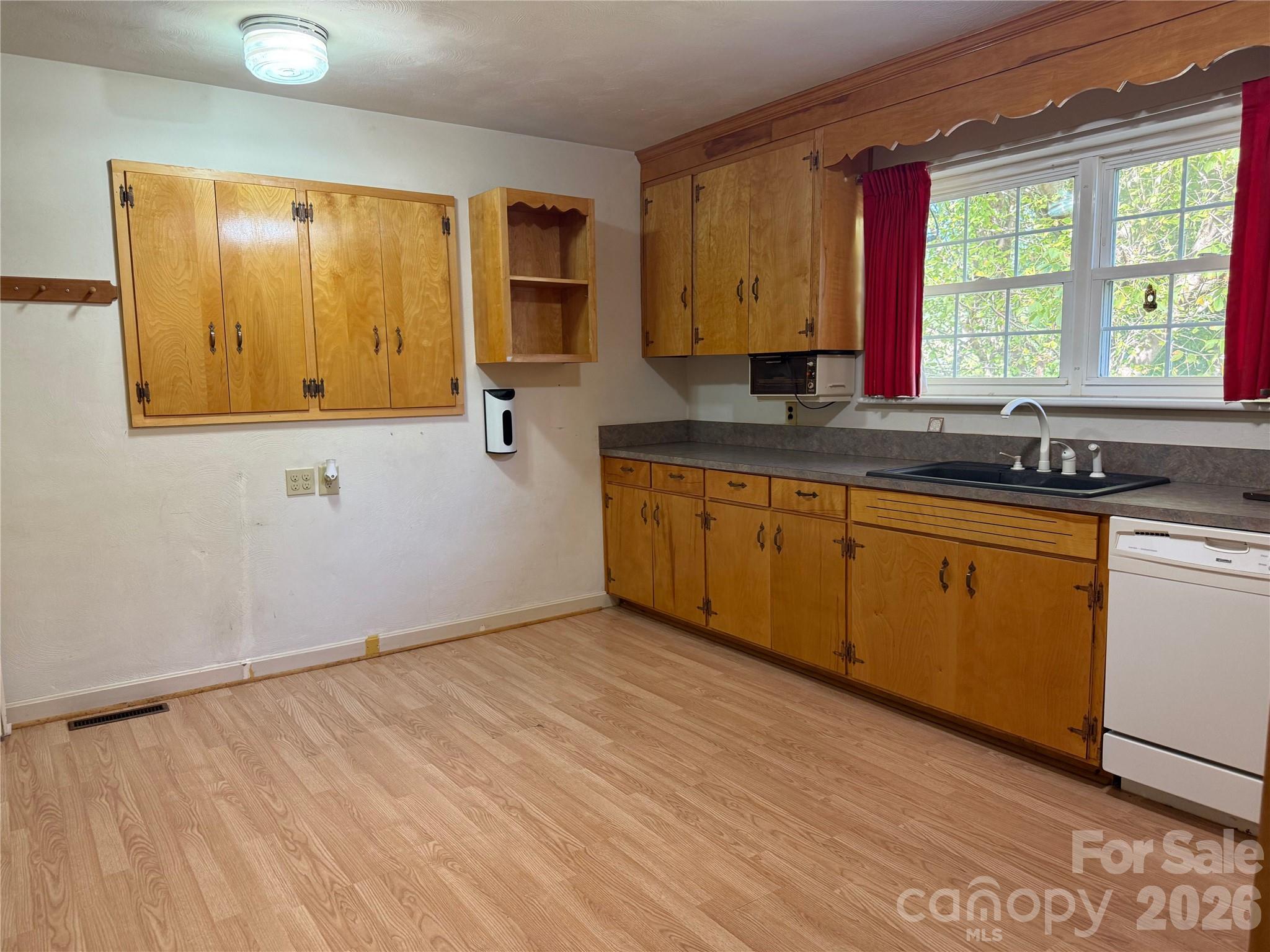 3532 16th Street Northeast, Unit 1 Hickory, NC 28601 - Photo 8 of 43 a view of a kitchen with wooden floor and a sink