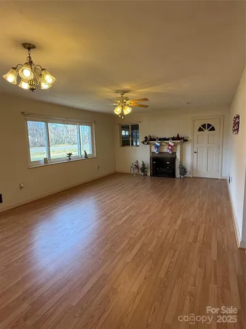 a view of a livingroom with furniture and an empty room