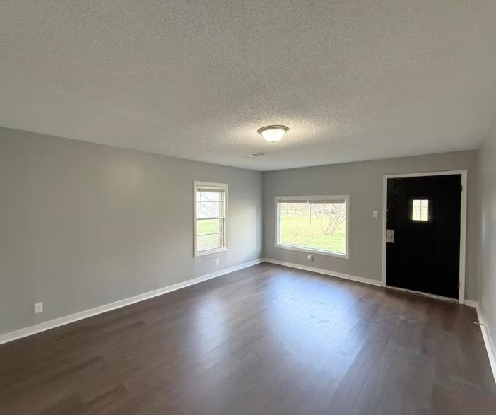 433 Dixie Road Memphis, TN 38109 - Photo 6 of 11 an empty room with wooden floor and windows