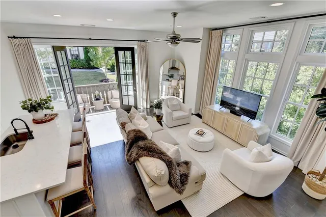 a living room with furniture and floor to ceiling windows