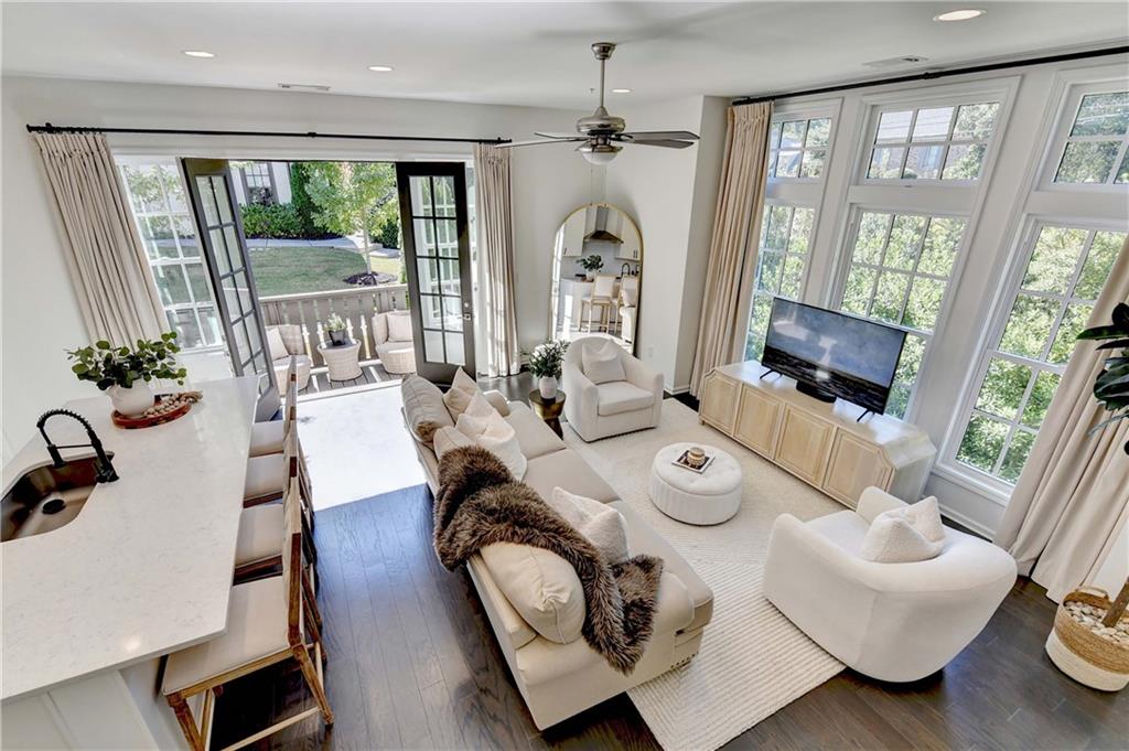 6602 Sterling Drive, Unit 688 Atlanta, GA 30328 - Photo 12 of 34 a living room with furniture and floor to ceiling windows