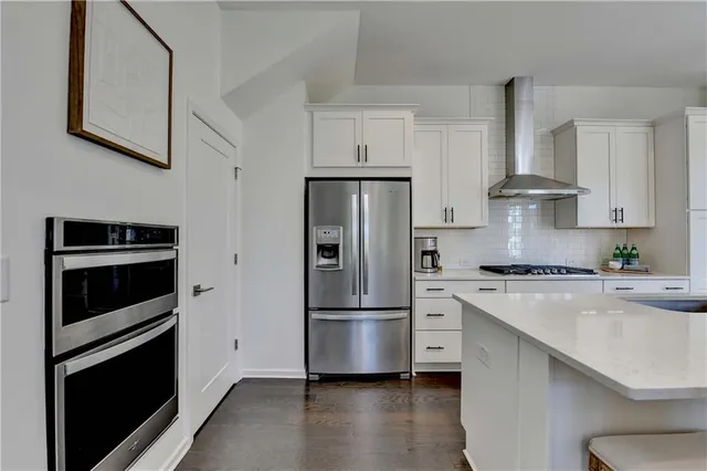 a kitchen with stainless steel appliances a refrigerator stove and sink