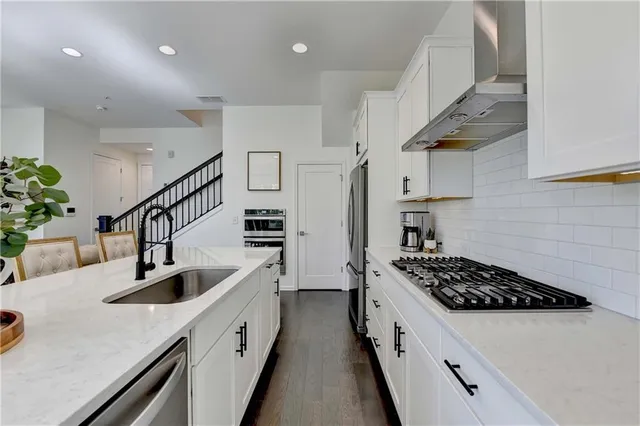 a kitchen with cabinets and a stove top oven