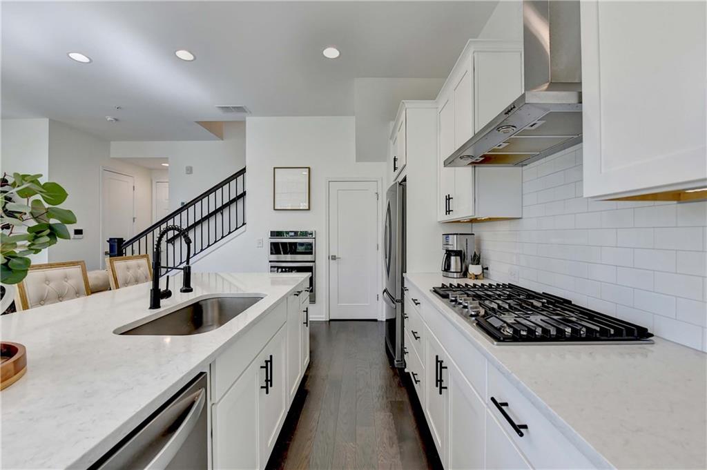 6602 Sterling Drive, Unit 688 Atlanta, GA 30328 - Photo 15 of 34 a kitchen with cabinets and a stove top oven