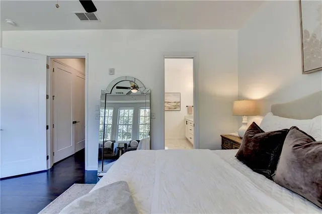 a bathroom with a double vanity sink a mirror a shower and a glass door