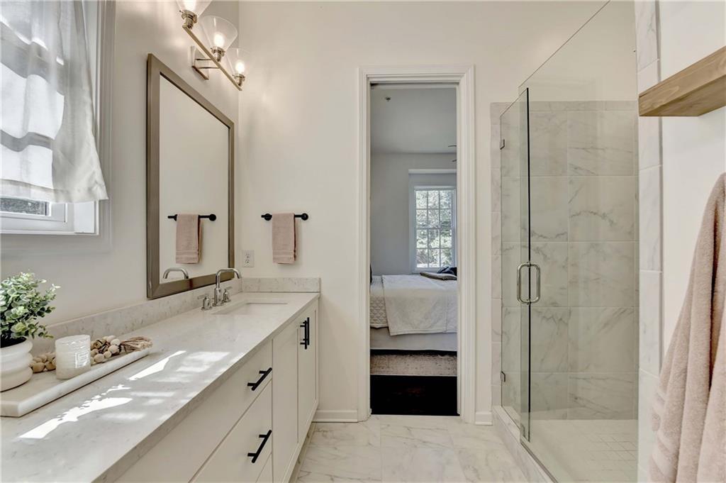 6602 Sterling Drive, Unit 688 Atlanta, GA 30328 - Photo 23 of 34 a bathroom with a granite countertop sink mirror and double