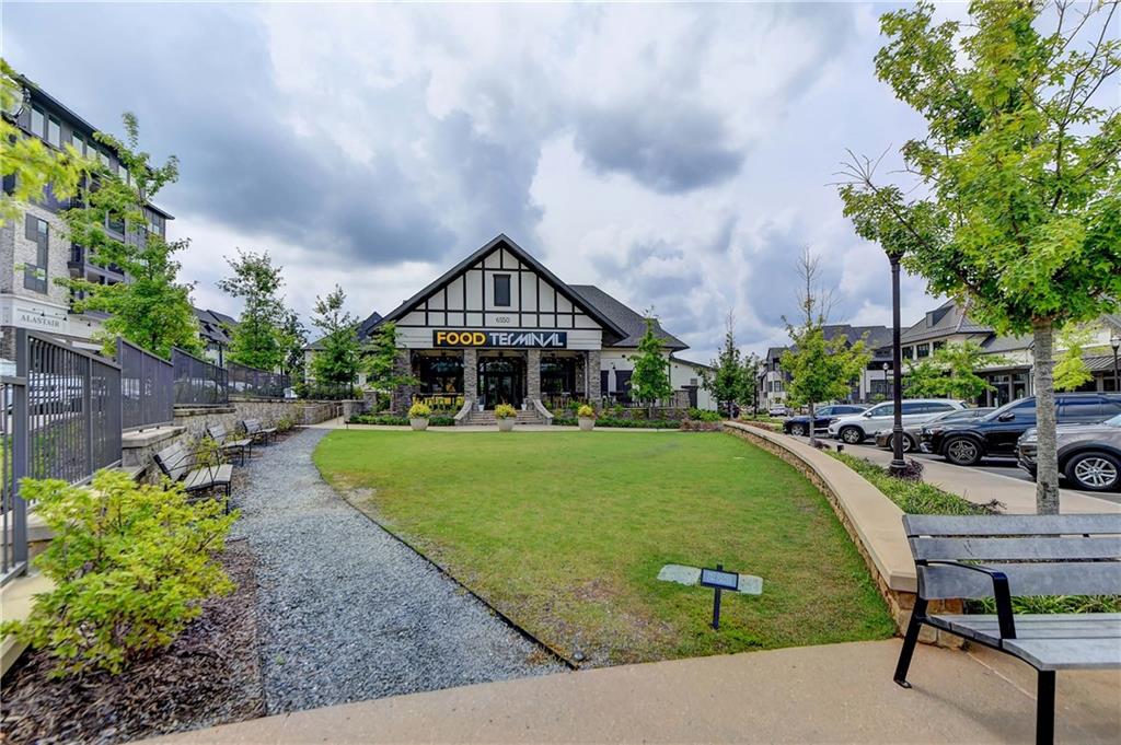 6602 Sterling Drive, Unit 688 Atlanta, GA 30328 - Photo 32 of 34 a front view of a house with garden