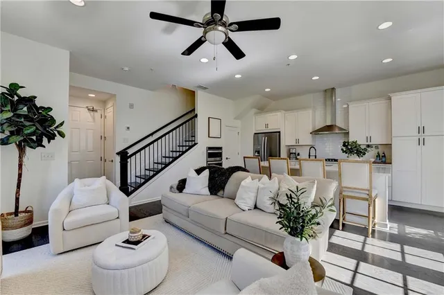 a living room with furniture and a potted plant