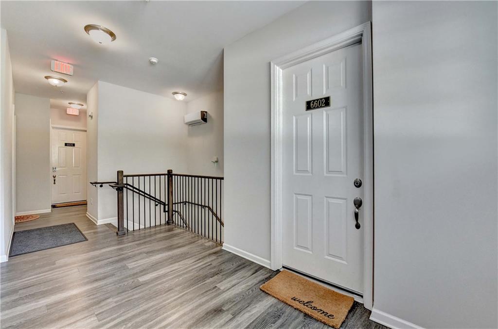 6602 Sterling Drive, Unit 688 Atlanta, GA 30328 - Photo 9 of 34 a view of a hallway with wooden floor and staircase