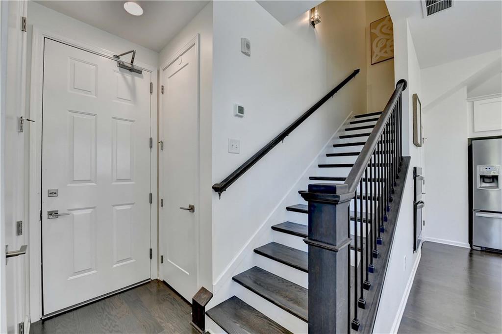 6602 Sterling Drive, Unit 688 Atlanta, GA 30328 - Photo 10 of 34 a view of entryway with wooden floor and stairs