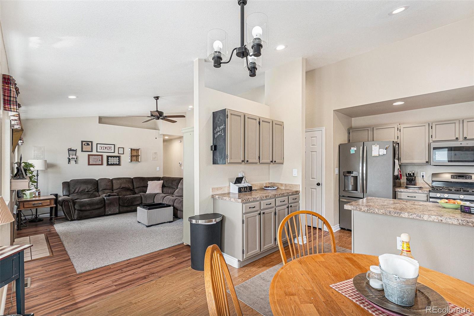 15482 Gadsden Drive Brighton, CO 80603 - Photo 11 of 43 a living room with furniture kitchen view and a chandelier