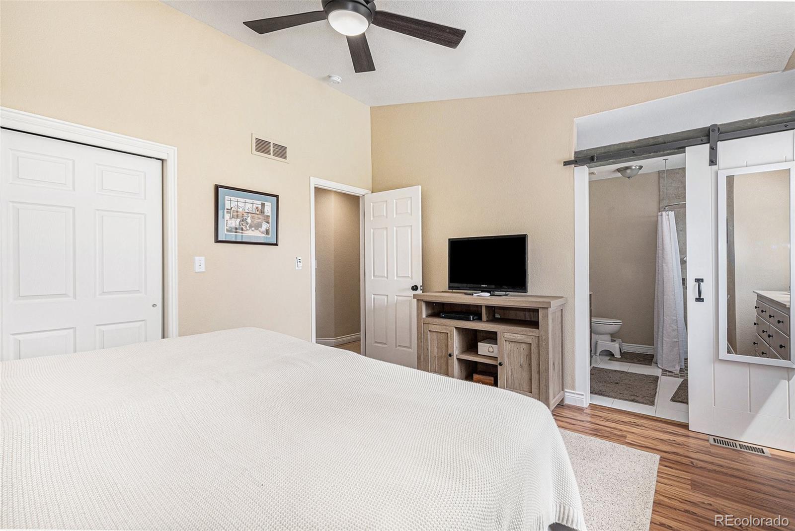 15482 Gadsden Drive Brighton, CO 80603 - Photo 16 of 43 a bedroom with a bed and a flat screen tv