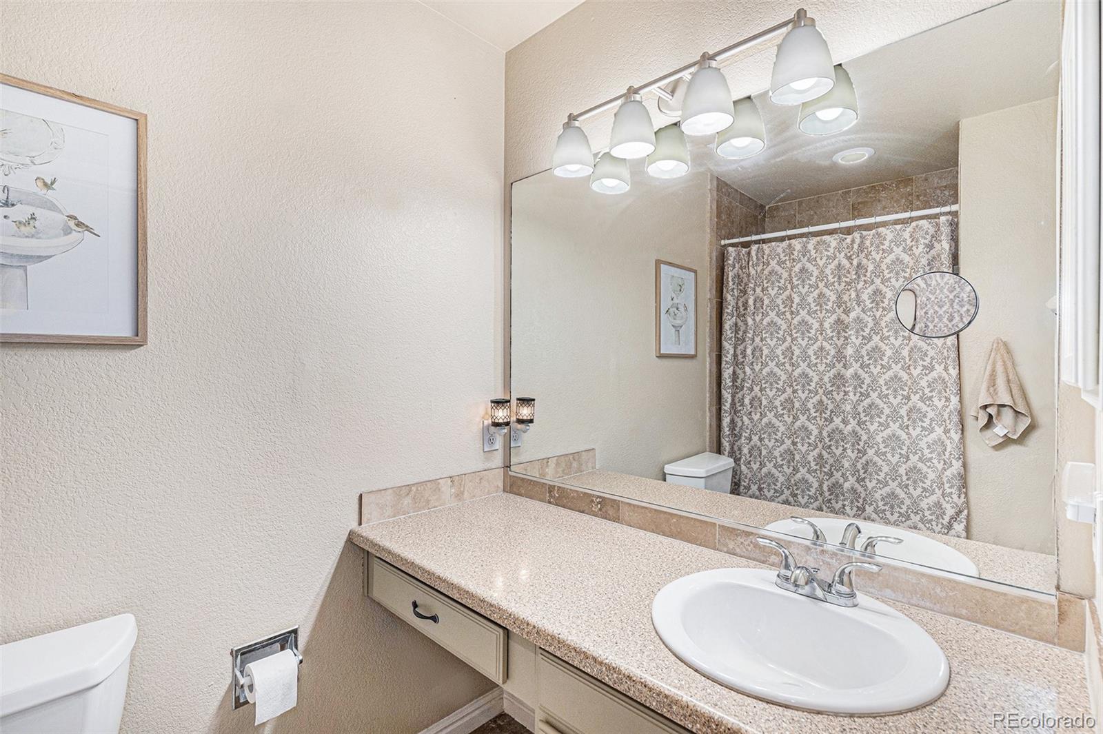 15482 Gadsden Drive Brighton, CO 80603 - Photo 23 of 43 a bathroom with a sink and a mirror
