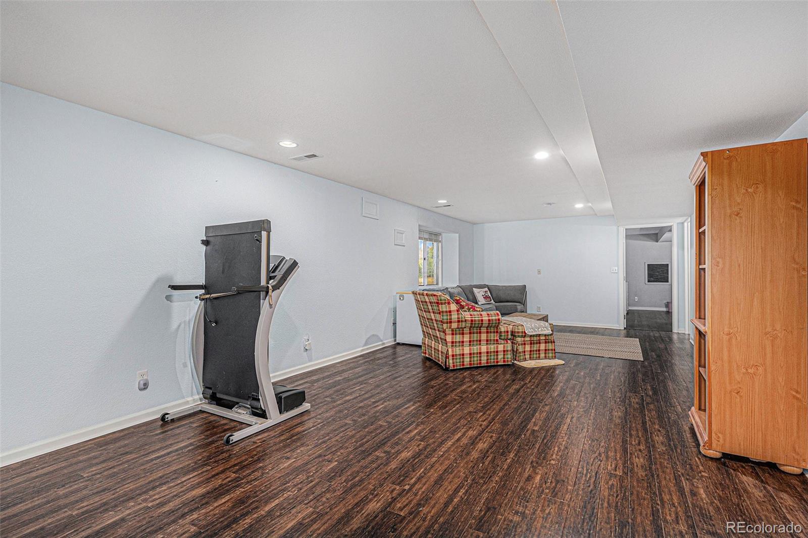15482 Gadsden Drive Brighton, CO 80603 - Photo 26 of 43 a view of a room with wooden floor and a refrigerator