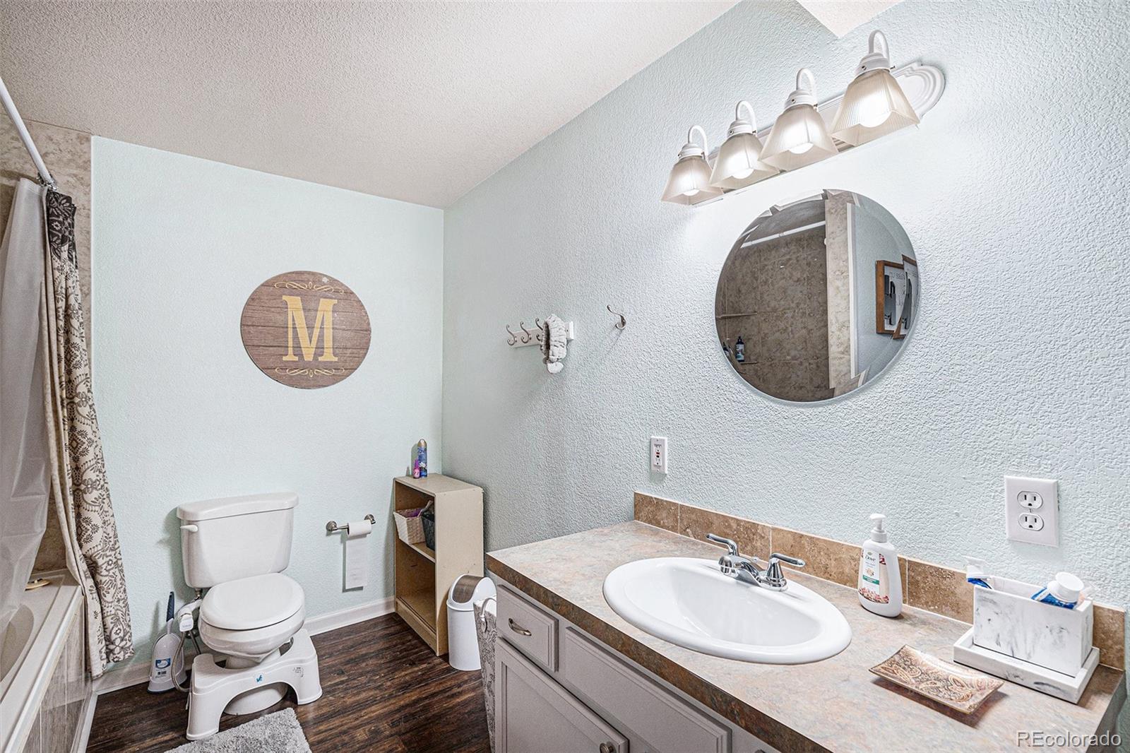 15482 Gadsden Drive Brighton, CO 80603 - Photo 30 of 43 a bathroom with a toilet a sink and a mirror